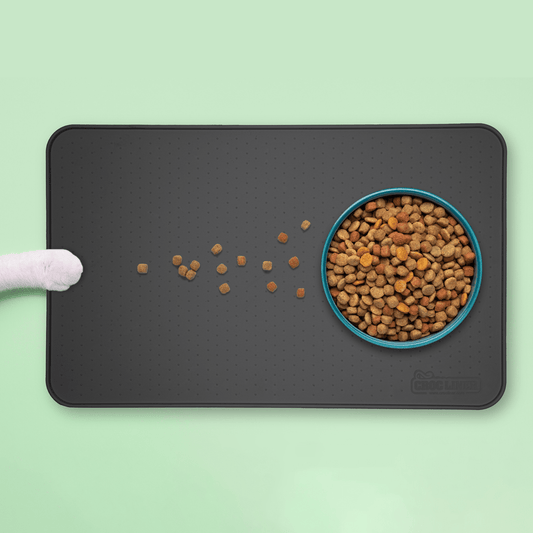 Silicone Pet Feeding Mat with a bowl of spilled food on it.