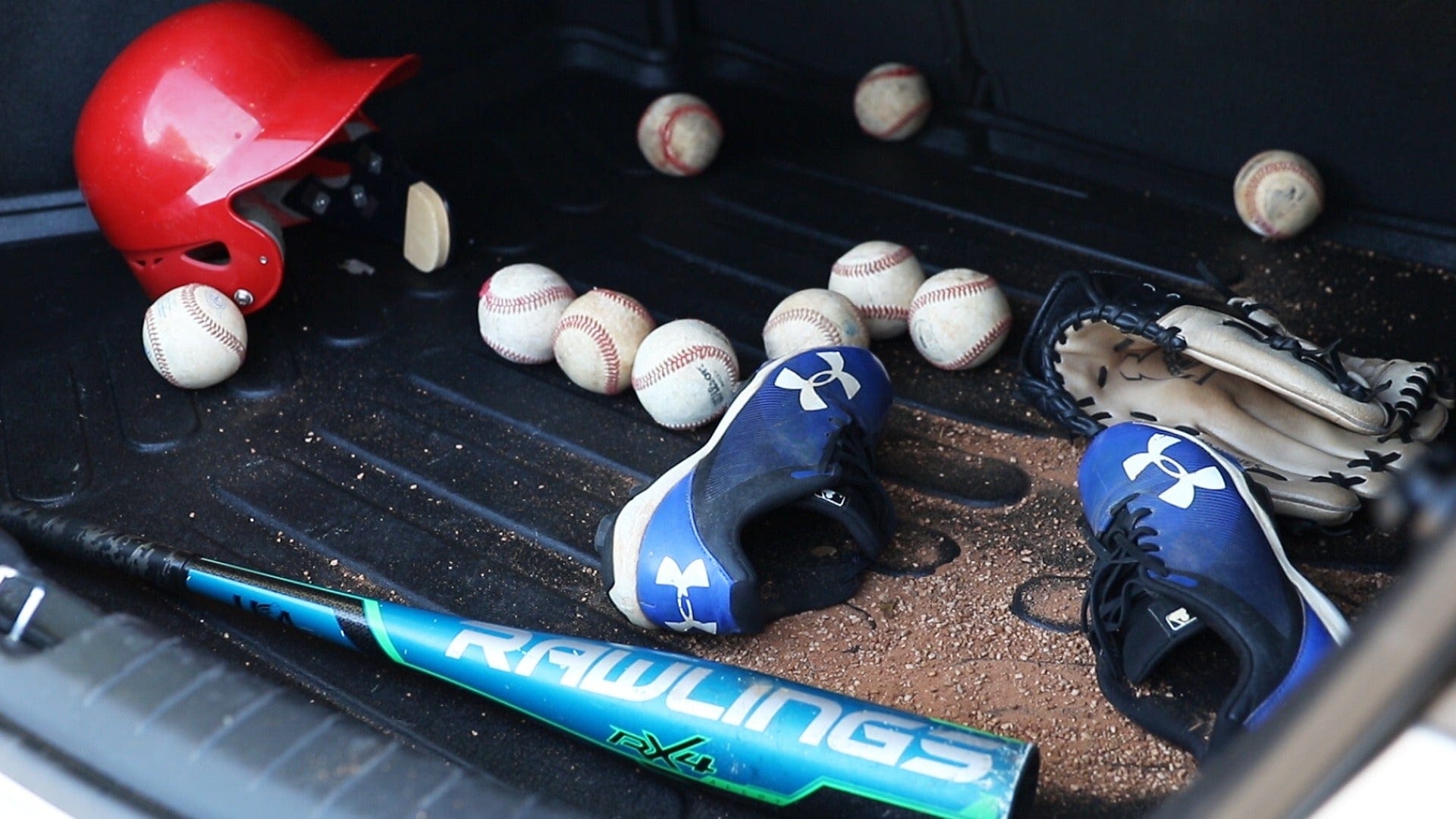  Cargo Liner with baseball gear and sand all over it.